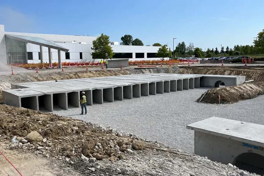 Concrete underground stormwater retention vault installation at a commercial site Concrete underground stormwater retention vault installation at a commercial site