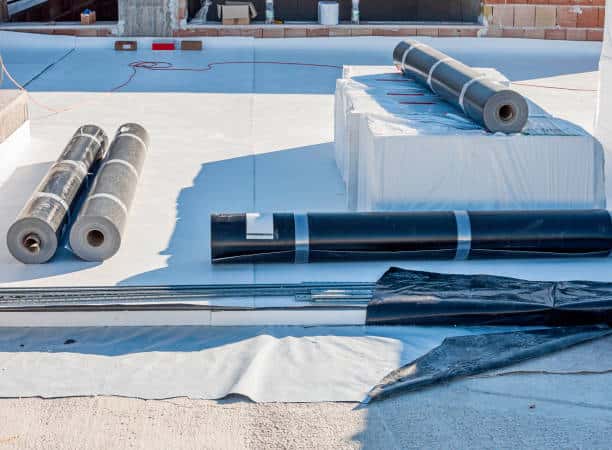 Rolls of TPO or EPDM waterproof membrane materials prepared on a commercial flat roof construction site Rolls of TPO or EPDM waterproof membrane materials prepared on a commercial flat roof construction site